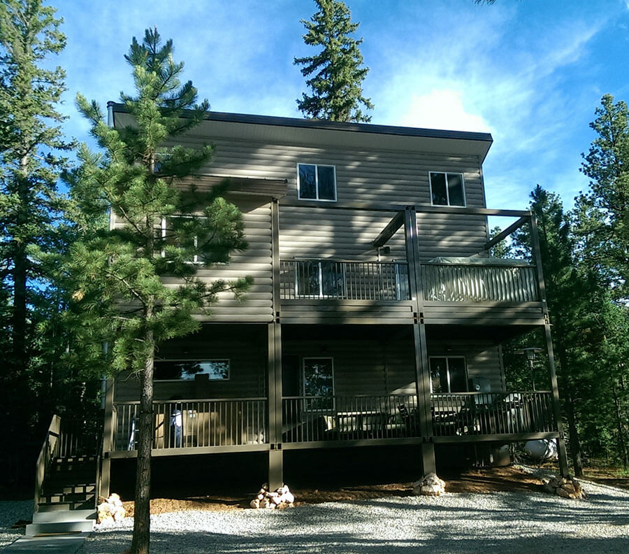 A three story Xtreme Cube residential home with ‘log cabin’ effect cladding to blend with the mountain landscape.